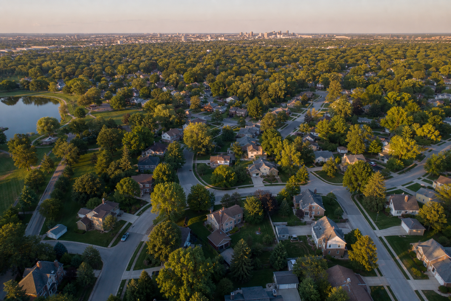 Aerial view of a leafy Kansas City metro neighborhood at golden hour